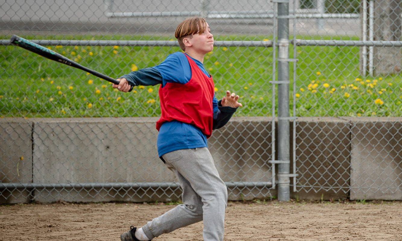 Un jeune homme joue à la ball-molle pendant un tournoi tenu lors du Festival des Sucres de Saint-Pierre-Baptiste